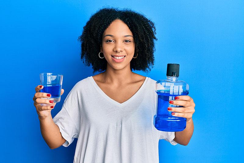 Woman holding mouthwash